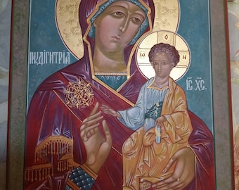 May include: A religious icon painting depicting the Virgin Mary holding the baby Jesus. The painting is done in a traditional style with gold accents and a blue background. The text "MP, OY, IC. XC" is visible in the painting.