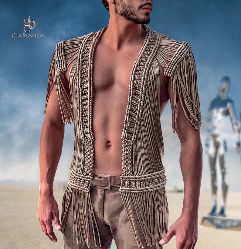 May include: A brown crocheted vest with fringe details. The vest is open in the front and has a knotted design.