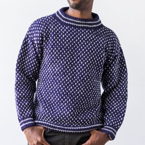 May include: A blue and white patterned sweater with a crew neck.