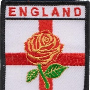 以下が含まれることがあります： 白と赤の刺繍パッチで、赤いバラと黒い文字で「ENGLAND」と書かれています。