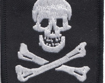 May include: White embroidered skull and crossbones on a black patch.