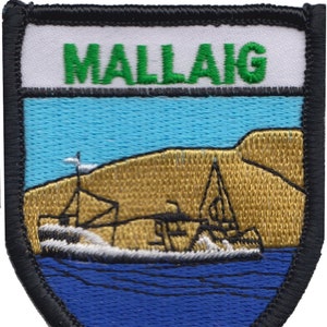 May include: A blue and white embroidered patch with the word "MALLAIg" in green letters. The patch features a stylized image of a boat in front of a brown hill.