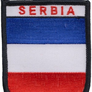 May include: A blue, white, and red embroidered patch with the word "SERBIA" in red letters.