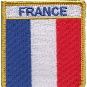 May include: Embroidered patch featuring the French flag, with blue, white and red stripes. The word "FRANCE" is embroidered in blue above the flag.