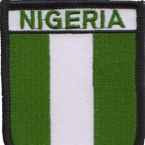 May include: A green, white, and green embroidered patch with the word "NIGERIA" in white lettering.