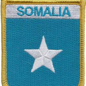 May include: A blue and white embroidered patch with a white star in the center and the word "SOMALIA" in white lettering at the top.