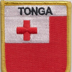 May include: A red, white, and red embroidered patch with the word "TONGA" in black lettering. The patch has a gold border.