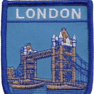 May include: A blue and white embroidered patch with the word "LONDON" at the top and a brown embroidered image of Tower Bridge below.