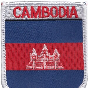 May include: Embroidered patch featuring the flag of Cambodia. The patch is blue, red, and white with the Cambodian flag's central design of Angkor Wat temple in white.