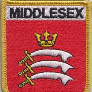May include: A red embroidered patch with a gold border. The patch features a white crown and three white swords with gold handles. The text "MIDDLESEX" is embroidered in black on a white background at the top of the patch.