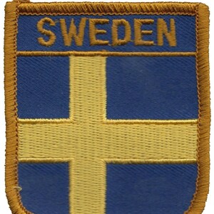 May include: A blue and yellow embroidered patch with the word "SWEDEN" in gold lettering.