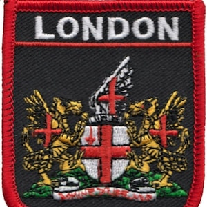 May include: A black embroidered patch with red stitching. The patch features the coat of arms of London, with two golden dragons, a shield with a red cross on a white background, and the text "LONDON" in white.