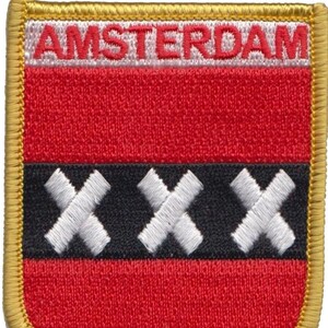 May include: Embroidered patch featuring the word "AMSTERDAM" above a red field, a black band with three white crosses, and a gold border. The patch is rectangular with rounded corners, suitable for jackets or bags.