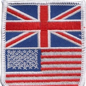 May include: Embroidered patch featuring a split design of the British Union Jack and the American flag. The top half displays the red and white cross of the Union Jack against a blue background. The bottom half shows the red and white stripes and stars of the American flag.