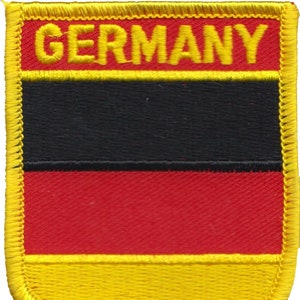 May include: A yellow, black, and red embroidered patch with the word "GERMANY" in yellow lettering.