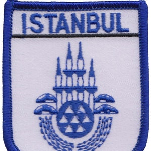 May include: Blue and white embroidered patch with the word "ISTANBUL" at the top and a stylized image of a building with a dome and minarets below.