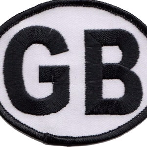 May include: White oval patch with black embroidered letters "GB" in the centre.