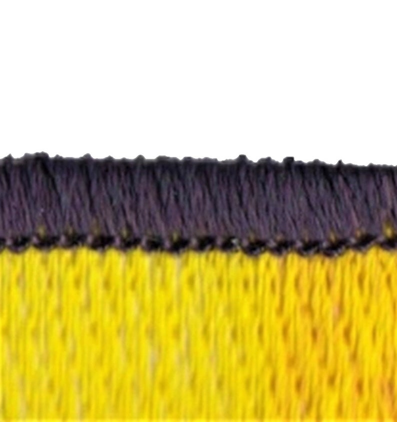 May include: Close-up of a yellow and black fabric with a black stitched border. The fabric has a textured, woven appearance.