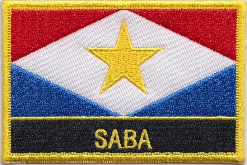 May include: A yellow embroidered patch with a red, white, and blue flag design. The flag has a yellow five-pointed star in the center. The word "SABA" is embroidered in yellow on a black background at the bottom of the patch.