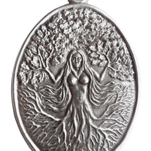 May include: Silver pendant featuring a woman with long hair, standing within a tree with roots and branches. The pendant is oval shaped and has a loop at the top for hanging.