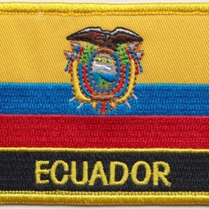 May include: An embroidered patch featuring the Ecuadorian flag. The flag has a yellow field with a blue, red and yellow horizontal stripe. The centre of the flag displays the Ecuadorian coat of arms, which depicts a condor with its wings spread. The patch is bordered in yellow and the word "ECUADOR" is embroidered in yellow on a black background.