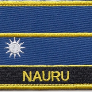 May include: An embroidered patch in blue and yellow with a white 12-pointed star in the centre and the word "NAURU" in yellow letters on a black background.