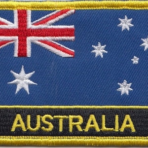 May include: A blue and white embroidered patch with the Australian flag and the word "AUSTRALIA" in yellow lettering on a black background.