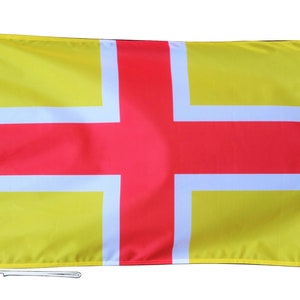 May include: A yellow flag with a red cross and white borders. The flag is hanging from a white pole.