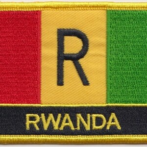 May include: An embroidered patch featuring the colours of the Rwandan flag, with a black "R" in the centre and the word "RWANDA" in black lettering on a black background.