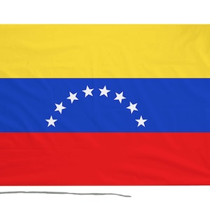May include: A Venezuelan flag with a yellow top stripe, a blue middle stripe with eight white stars in a semi-circle, and a red bottom stripe.