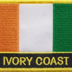 May include: An embroidered patch featuring the flag of Ivory Coast. The flag is orange, white and green. The patch has a black border with the words "Ivory Coast" in yellow lettering.