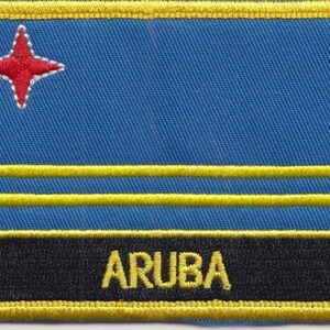 May include: A blue patch with a red star and two yellow stripes. The word "ARUBA" is written in yellow letters on a black background.