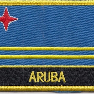 May include: A blue and yellow embroidered patch with a red star and the word "ARUBA" in yellow lettering.