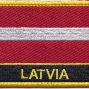May include: Embroidered patch featuring the Latvian flag, with a red background and a white horizontal stripe in the centre. The patch has a black border with the word "LATVIA" in yellow lettering.