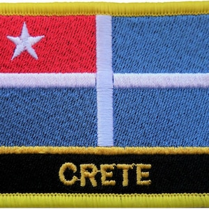 May include: A yellow, black, and white embroidered patch with a blue and white flag and the word "CRETE" in yellow letters.