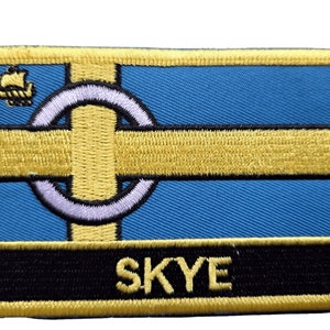 May include: A yellow and blue embroidered patch with a white circle and a yellow cross. The patch has a black background with the word "SKYE" in yellow letters.
