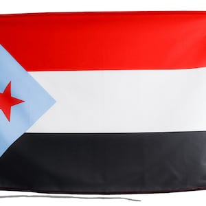 May include: A red, white, and black flag with a blue triangle in the upper left corner containing a red star.