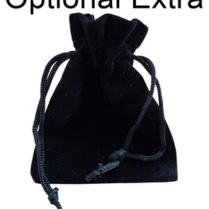 May include: A black velvet drawstring pouch with a black cord.