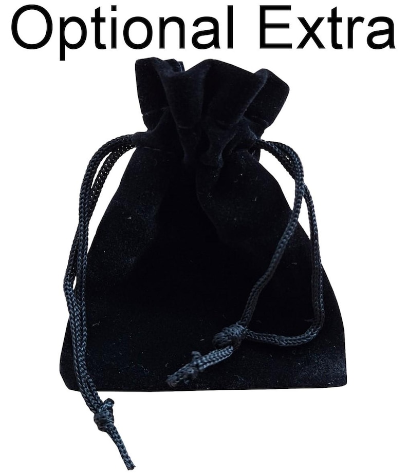 May include: A black velvet drawstring pouch with a black cord.