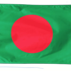 May include: A green flag with a large red circle in the centre. The flag is made of a soft, flowing fabric.
