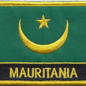 May include: An embroidered patch in green with a yellow crescent moon and star, and the word "MAURITANIA" in yellow lettering on a black background.