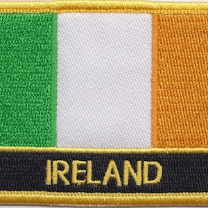 May include: A green, white, and orange embroidered patch with the word "IRELAND" in gold lettering on a black background.