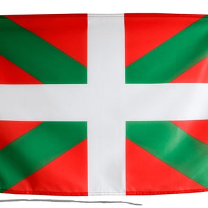 May include: A rectangular flag featuring a white cross on a red background, with green diagonal stripes. The flag is made of a lightweight material and is attached to a white fabric strip.