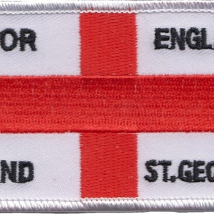 May include: White and red embroidered patch with the text "FOR ENGLAND AND ST. GEORGE" in black.