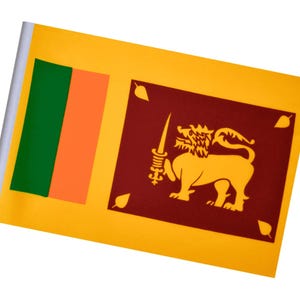 May include: A small flag of Sri Lanka, featuring a yellow background with a maroon panel. The panel displays a golden lion holding a sword. The flag also has green and orange vertical stripes on the left side.