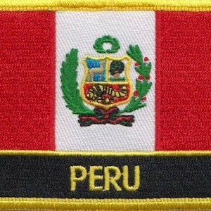 May include: A red, white, and red embroidered patch with the coat of arms of Peru and the word "PERU" in yellow lettering.