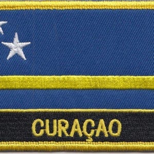 May include: A blue and yellow embroidered patch with two white stars and the word "CURAÇAO" in yellow lettering.