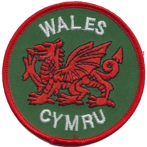 May include: A green and red embroidered patch with a red dragon and the words "WALES" and "CYMRU" in white.