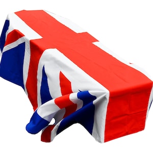 May include: A Union Jack flag draped over a rectangular object, possibly a table or a box.