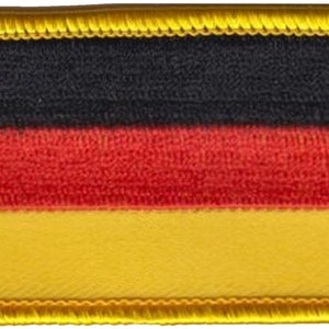 May include: A black, red and yellow fabric patch with a gold border. The patch features the colours of the German flag.
